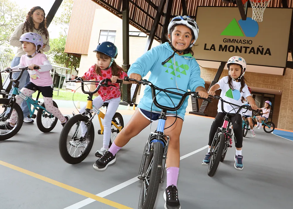 Niños montan bicicleta en el campus del Gimnasio La Montaña, colegio en Bogotá